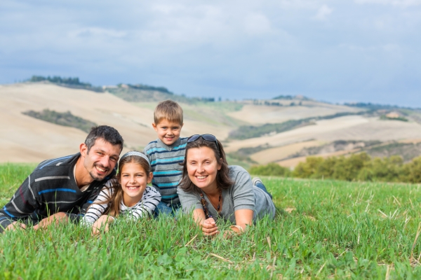 Happy family having fun outdoors in Tuscan